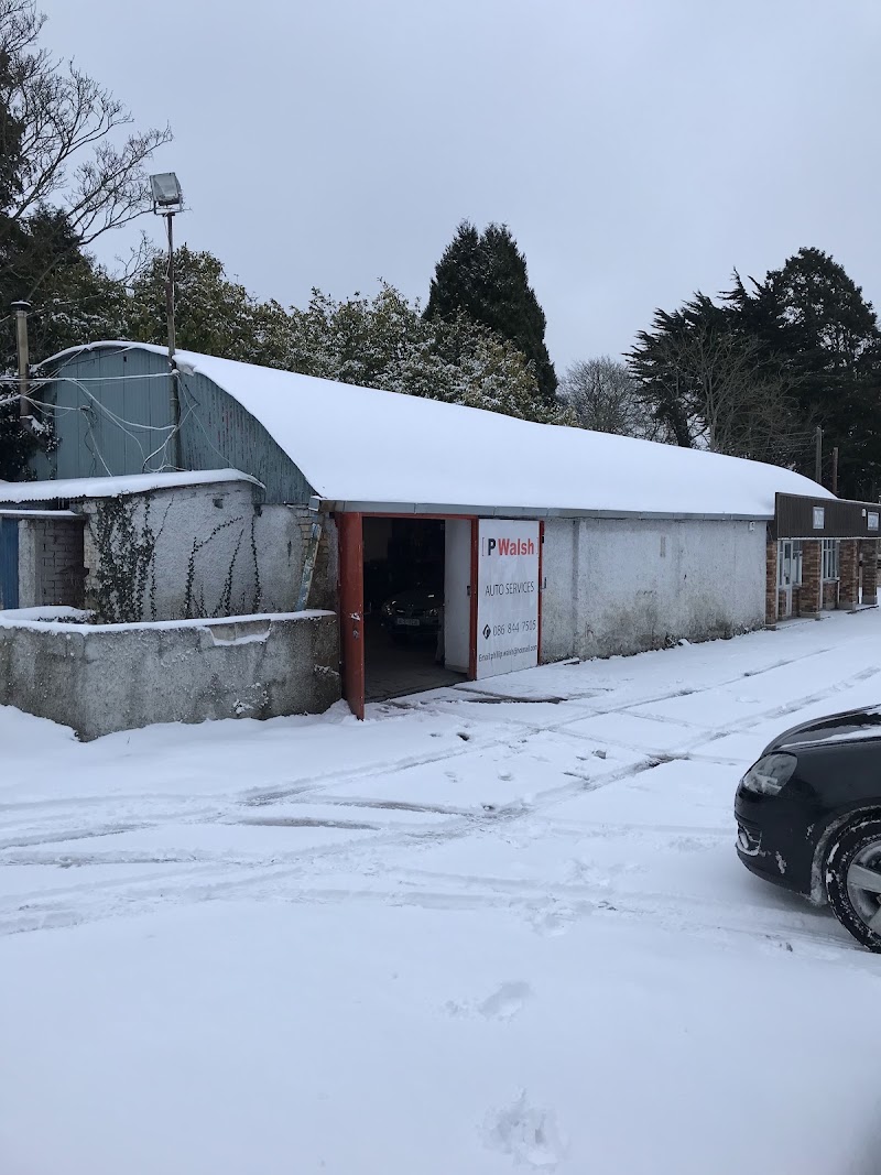 The P Walsh Auto Services workshop at Dunsinea Works, with the red P Walsh sign beside the open bay